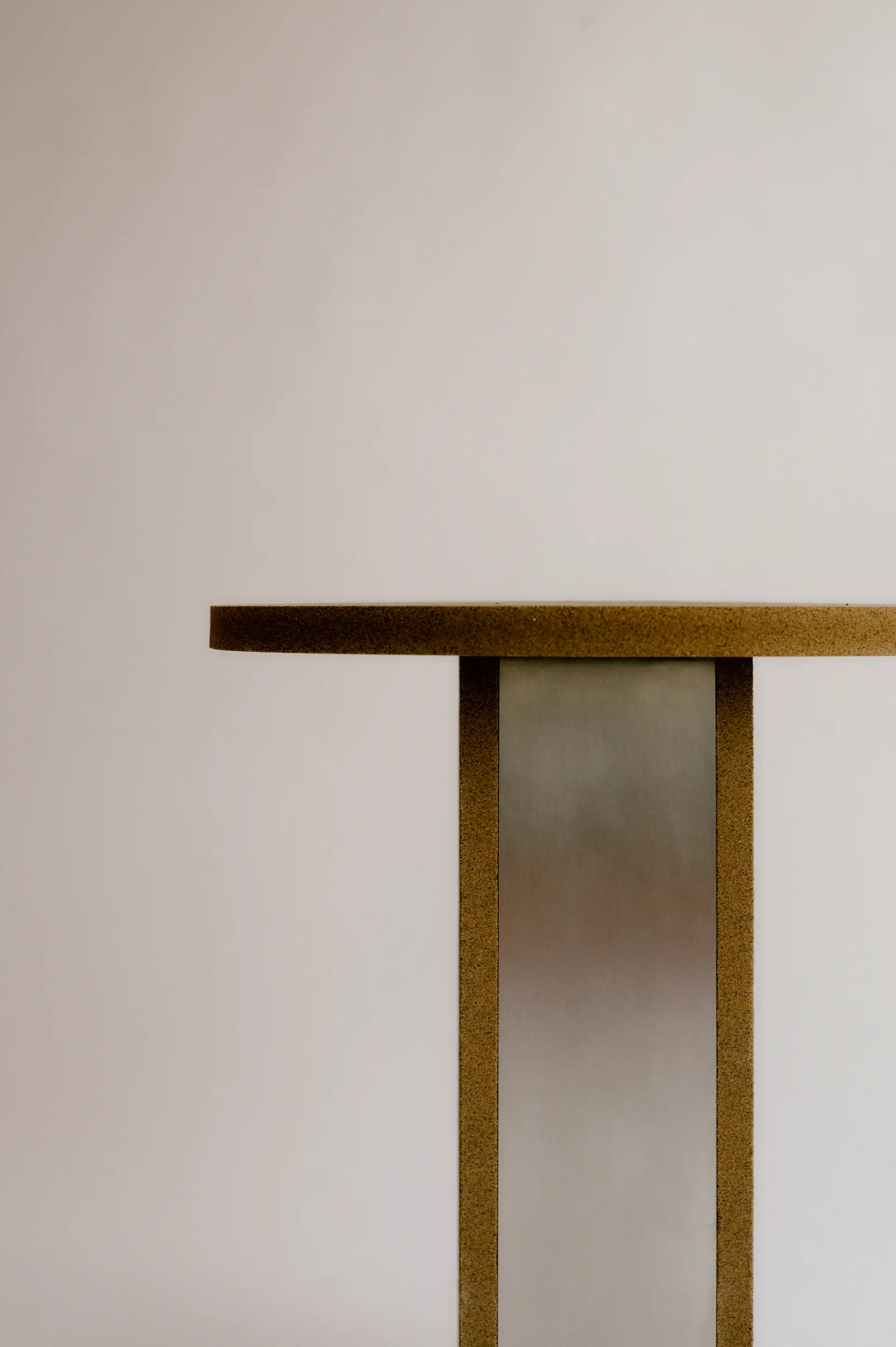 Side profile of olive pit based material next to cork, highlighting material shift from familiar by-product to design innovation